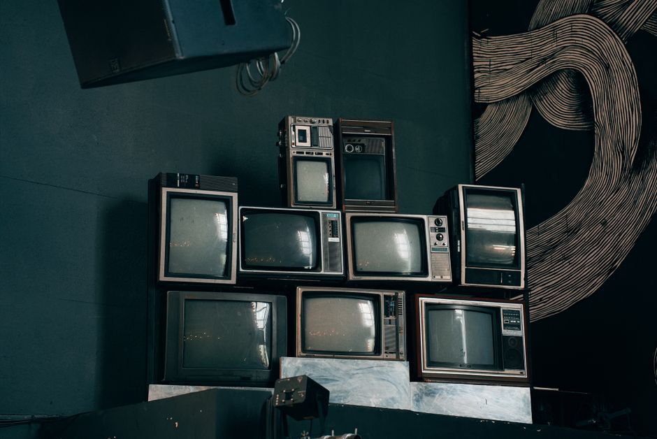 a stack of old television sets