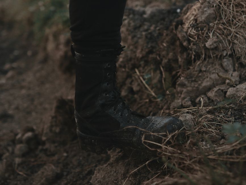 close-up of military boots on rugged terrain