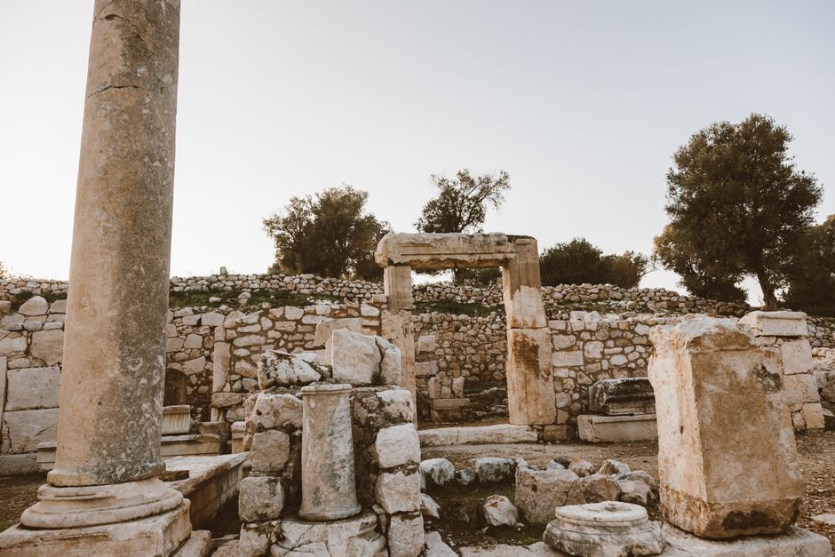 A scenic view of ancient stone ruins captured at sunset, showcasing historical architecture.
