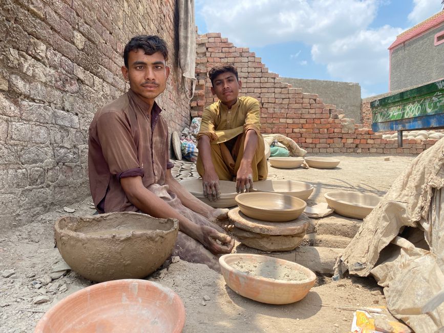 Young potters crafting clay pots in Thikratho, Sindh, embodying cultural heritage.