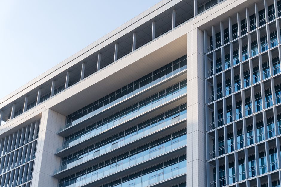 Close-up view of a modern glass and concrete highrise building facade.