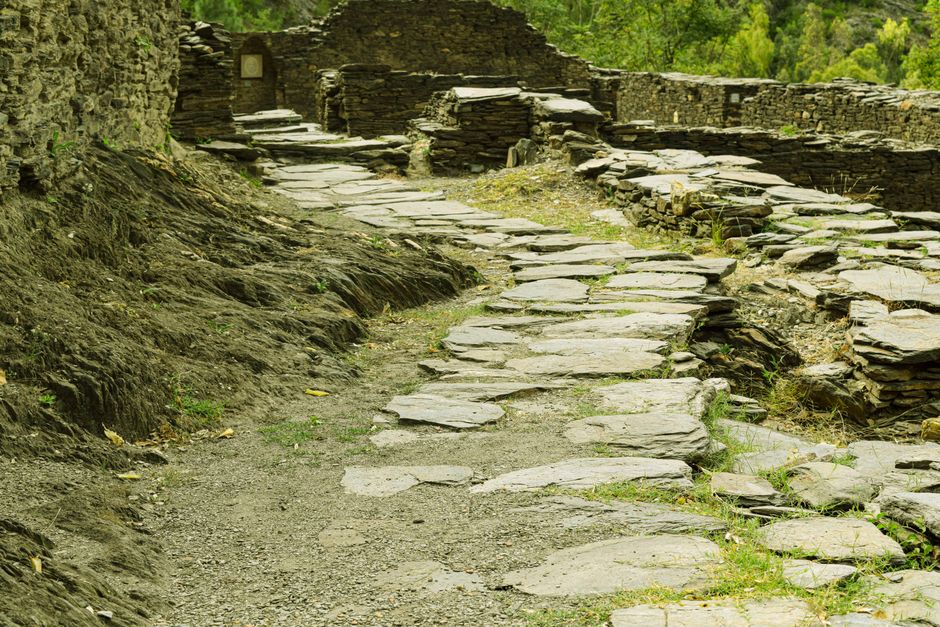 Explore the historic stone pathway in Odigram, Pakistan, leading through ancient ruins.