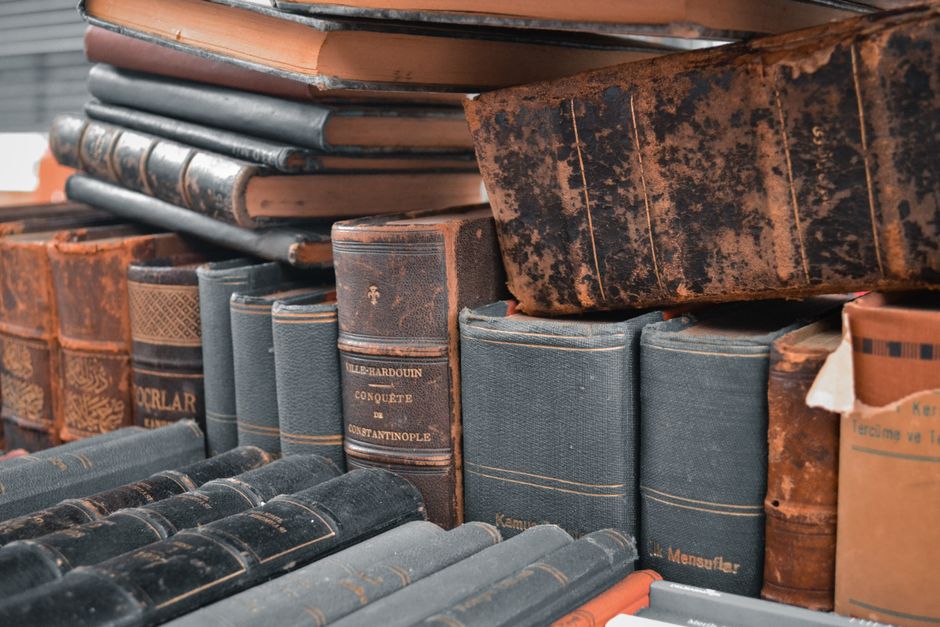 A detailed shot of antique leather-bound books stacked closely. Perfect for historical or literary themes.