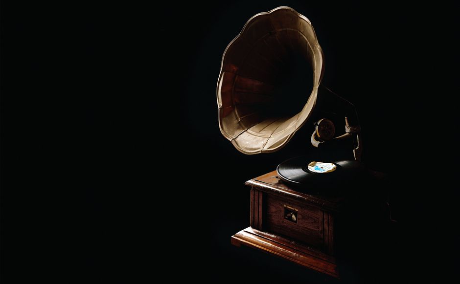 A classic gramophone with vinyl record, showcasing vintage charm in a dark ambiance.