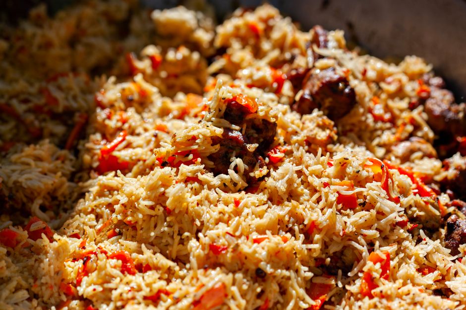 Mouthwatering close-up of a delicious biryani dish with spices and tomatoes.