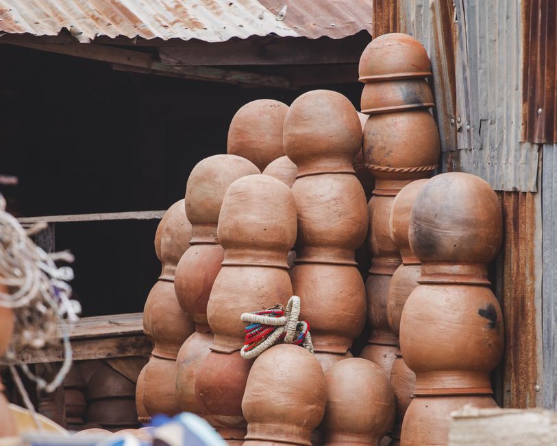 Stack of traditional clay pots in rustic outdoor setting, perfect for cultural and artistic themes.