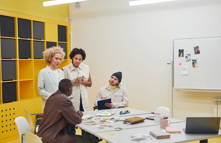 A diverse group of professionals having a collaborative meeting in a modern office space.