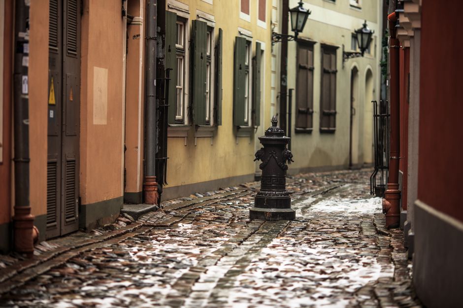 Charming cobblestone alley in a European city during a winter day.