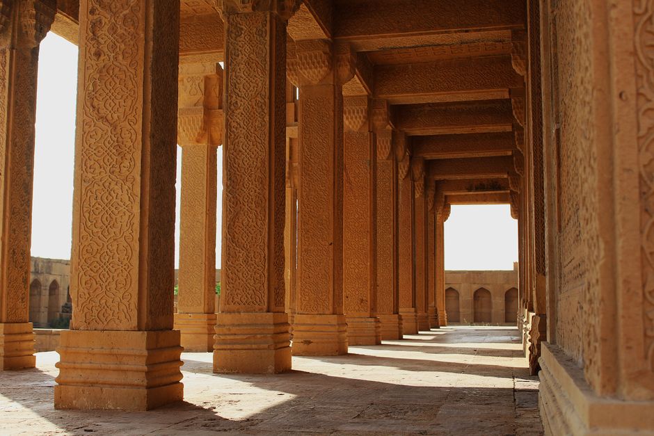Intricate stone carvings in the corridor of Makli Necropolis, Thatta, showcasing historical Sindhi architecture.