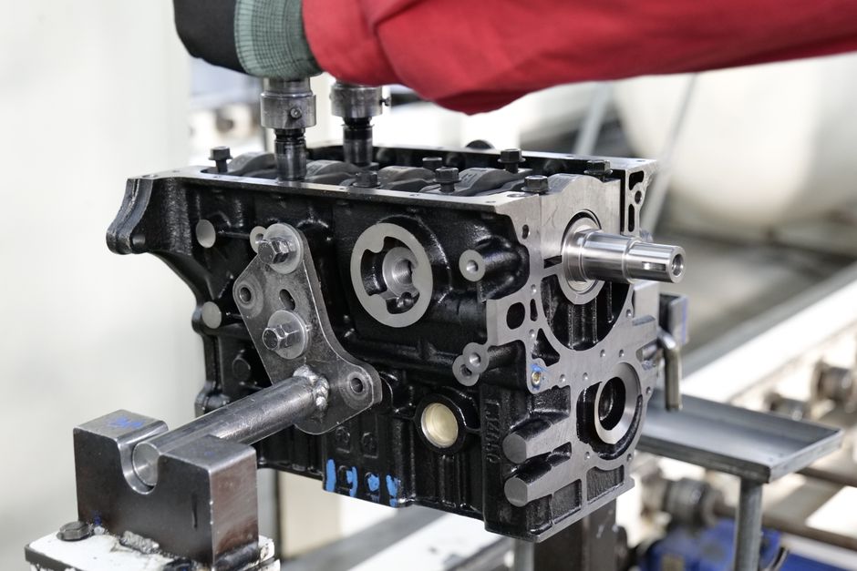 Close-up of engine assembly process highlighting industrial precision
