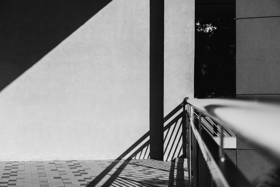 Minimalist black and white photo capturing architectural shadow play and geometric forms.