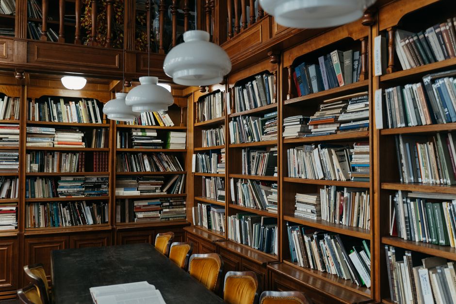 A serene library with wooden shelves filled with books, creating a cozy academic atmosphere.