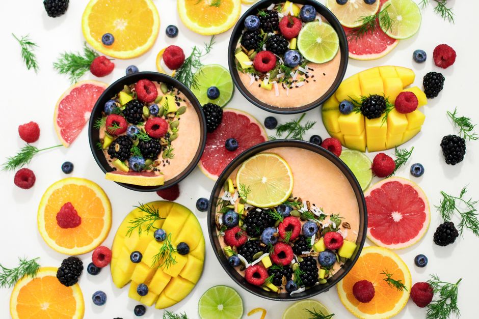 A colorful assortment of fresh fruit bowls featuring mixed berries and citrus slices, perfect for healthy eating inspiration.