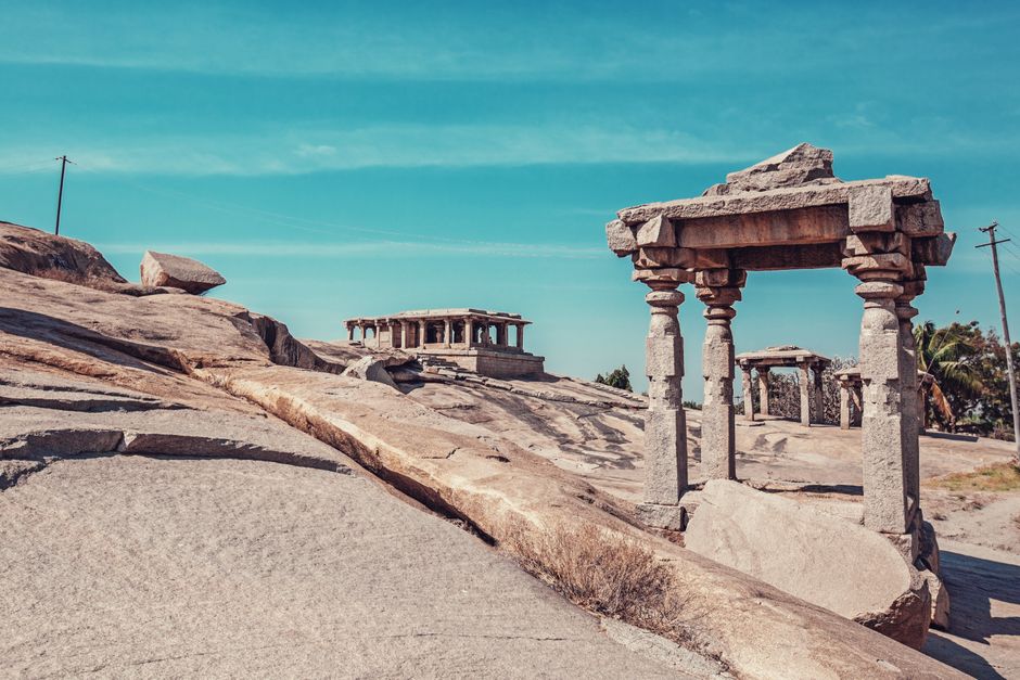 Amazing remnants of stone constructions with pillars in aged district of Anegundi in Hampi