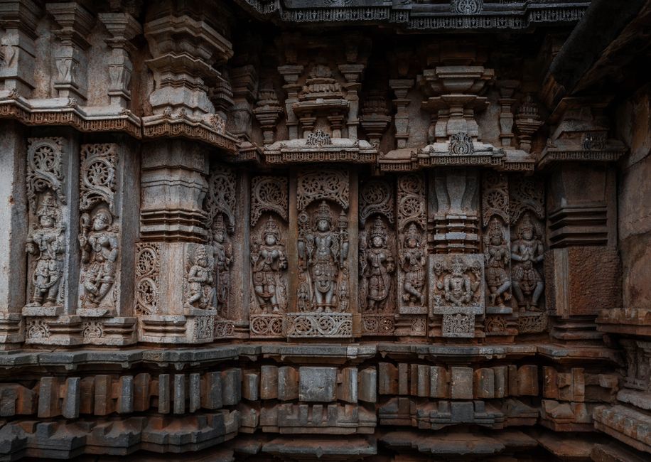 Detailed stone carvings on the wall of Belavadi Temple in Karnataka, India, showcasing ancient craftsmanship.