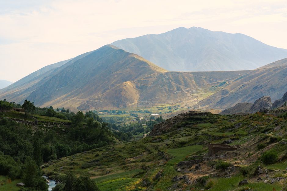 A breathtaking landscape of Panjshir Valley with lush greenery and towering mountains.