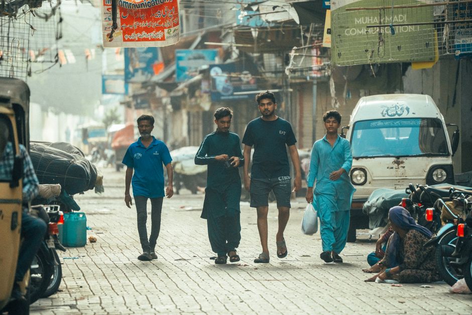 Image 2 A group of people walking through a vibrant Karachi street, capturing daily urban life.