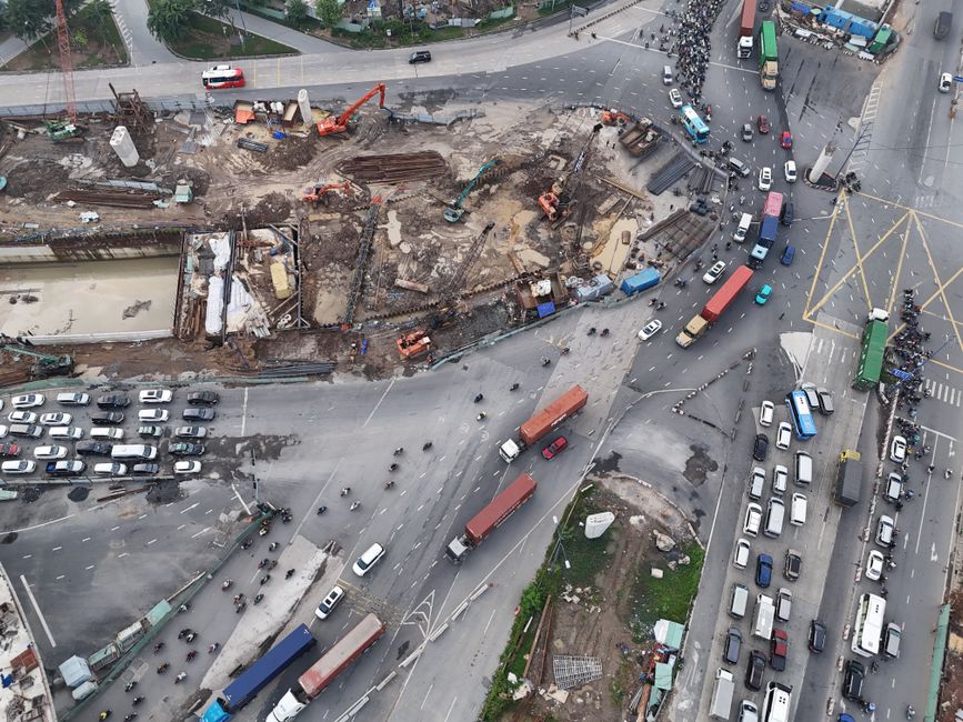 Aerial photograph showcasing construction activity and heavy traffic at a busy city intersection.