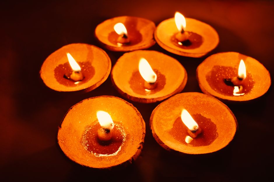 Illuminated clay oil lamps create a warm glow, ideal for festive celebrations.