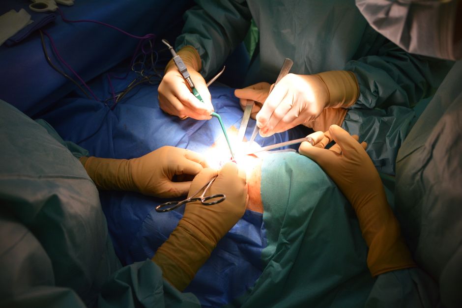 Close-up view of surgeons in an operating room performing a surgery with precision.