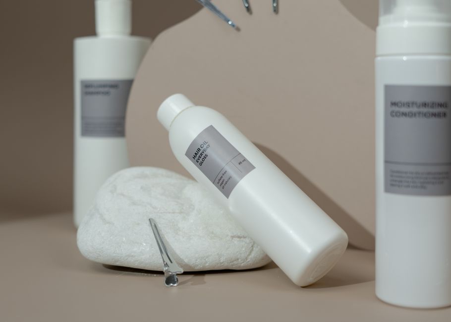 Close-up of various hair care products elegantly displayed with soft lighting for spa use.