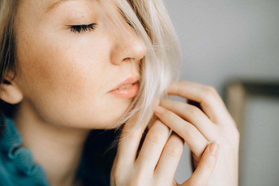 A close-up portrait of a serene woman with closed eyes and soft lighting, highlighting her delicate features.